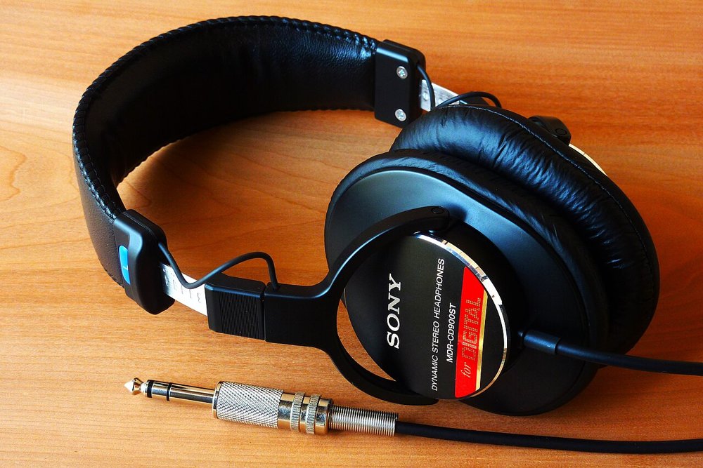 木目の机に置かれたSONY MDR-CD900STの密閉型モニターヘッドホン
